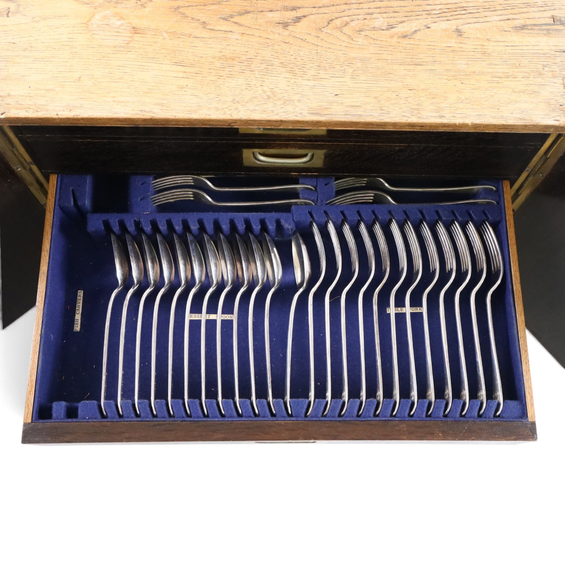 Ealy 20th century oak canteen, with five drawers behind double doors, four drawers containing a part set of silver plated Hanoverian pattern cutlery with engraved monograms and a set of twelve mother of pearl handled fruit knives and forks, the last drawer containing a collection of loose silver plated cutlery, canteen H39cm, W48cm