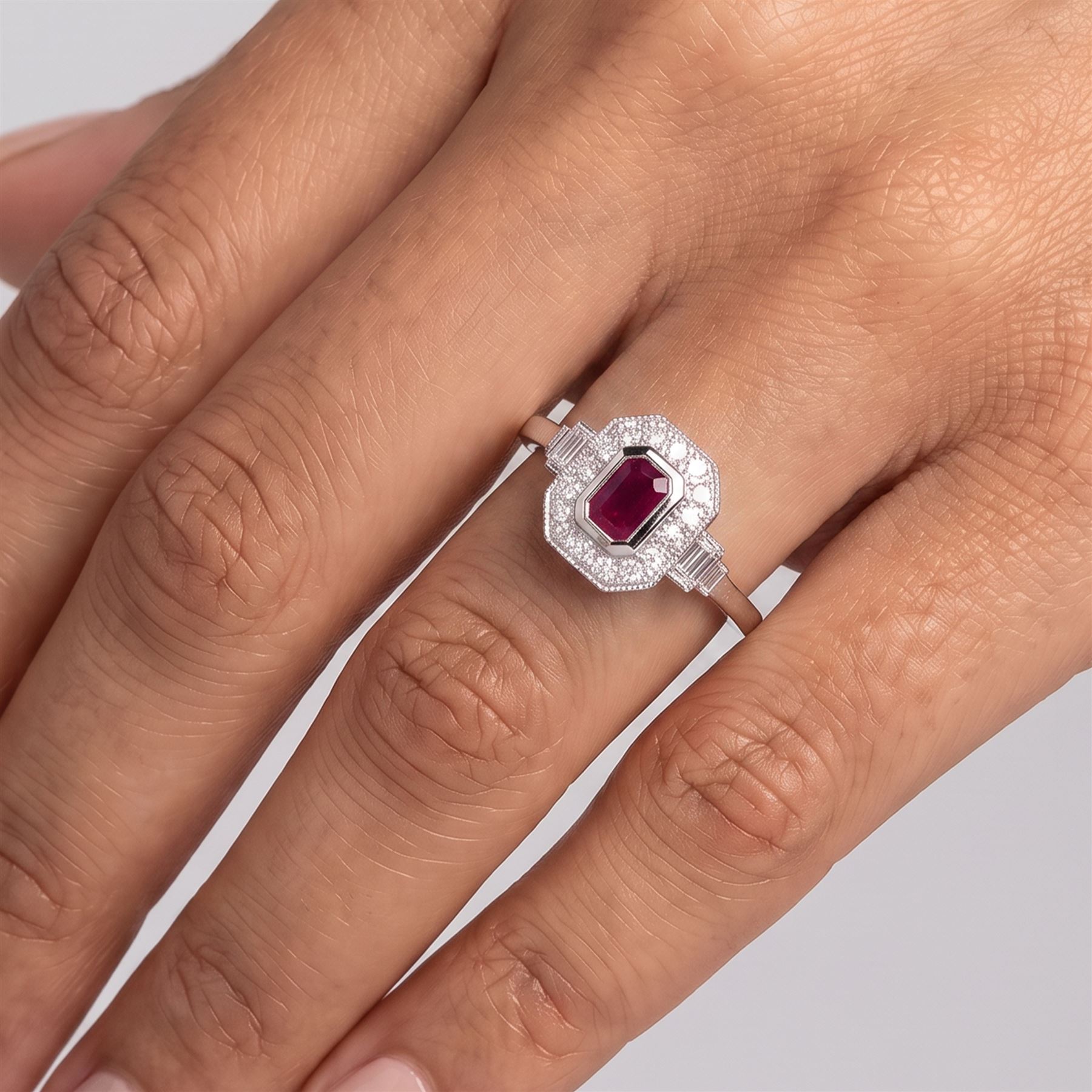 Platinum ruby and diamond ring, single octagonal cut ruby of approx 0.60 carat, with milgrain set round brilliant cut diamond surround and baguette cut diamond shoulders, hallmarked, total diamond weight approx 0.45 carat