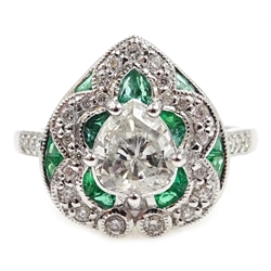  White gold heart shaped ring, central pear shaped diamond with emerald and diamond surround, stamped 18K, central diamond approx 0.7 carat  