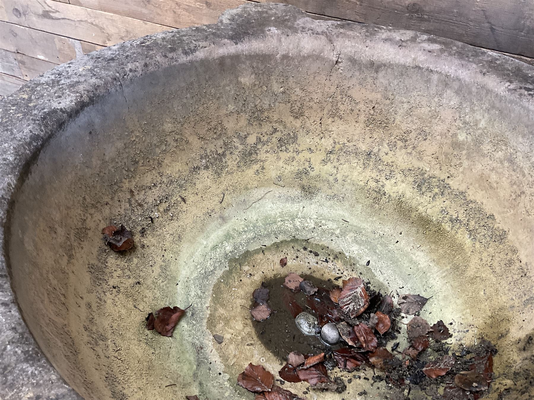 Large 19th century circular stone mortar planter on wrought iron stand