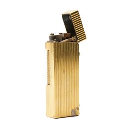 Dunhill - Rollagas lighter, gilt metal with vertical reeded decoration and ribbed thumbpiece, H6.5cm 