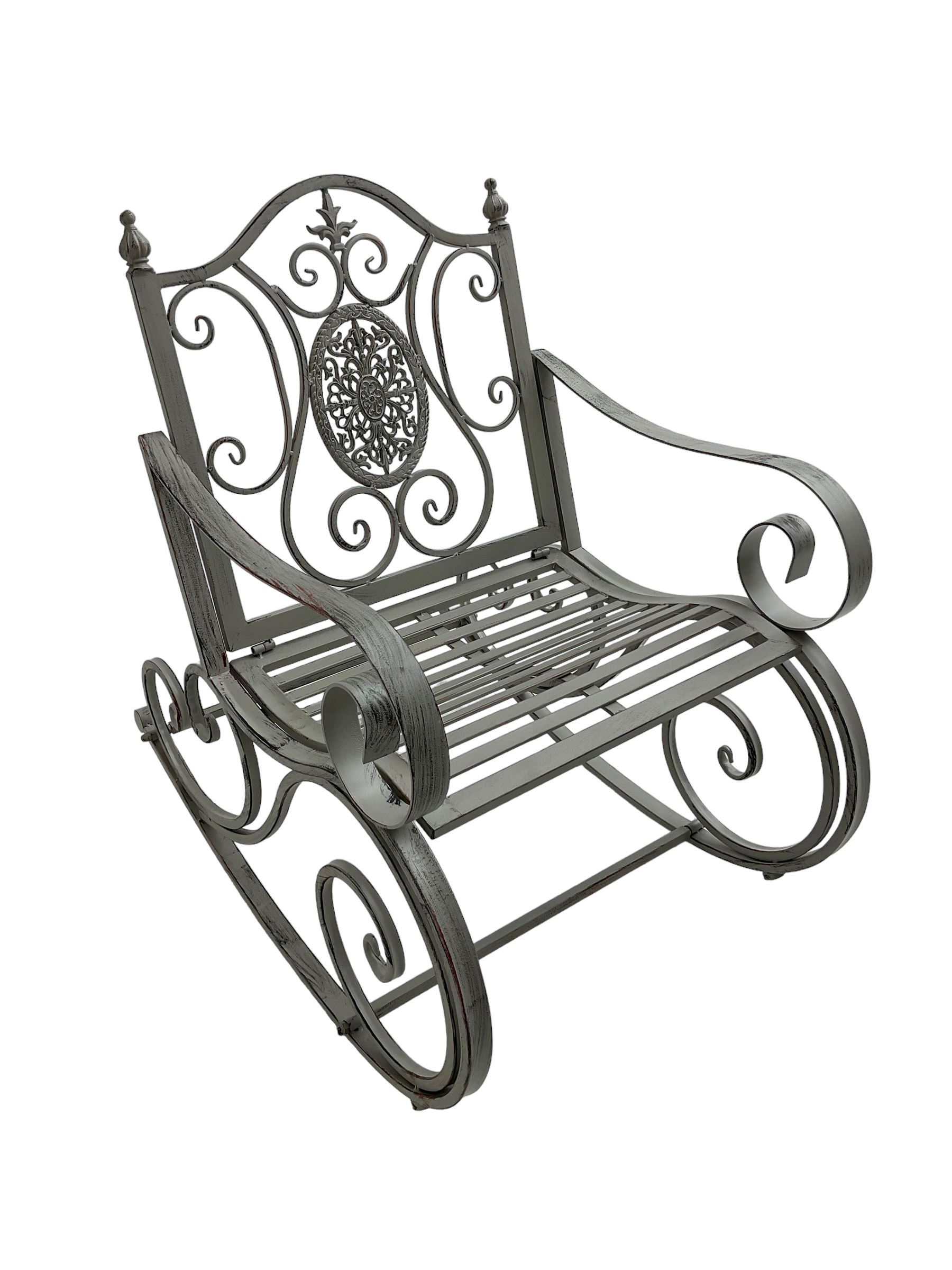Regency design wrought metal rocking garden bench armchair, pierced back with scroll design and central foliate medallion over strap seat, with C-scroll arms and supports, in antique grey finish