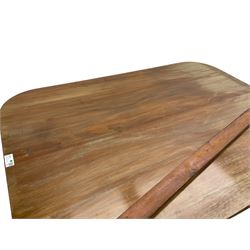 Regency mahogany dining table, rectangular top with rounded corners and reeded edge, raised on square pedestal with platform, terminating to sabre supports with brass cups and castors