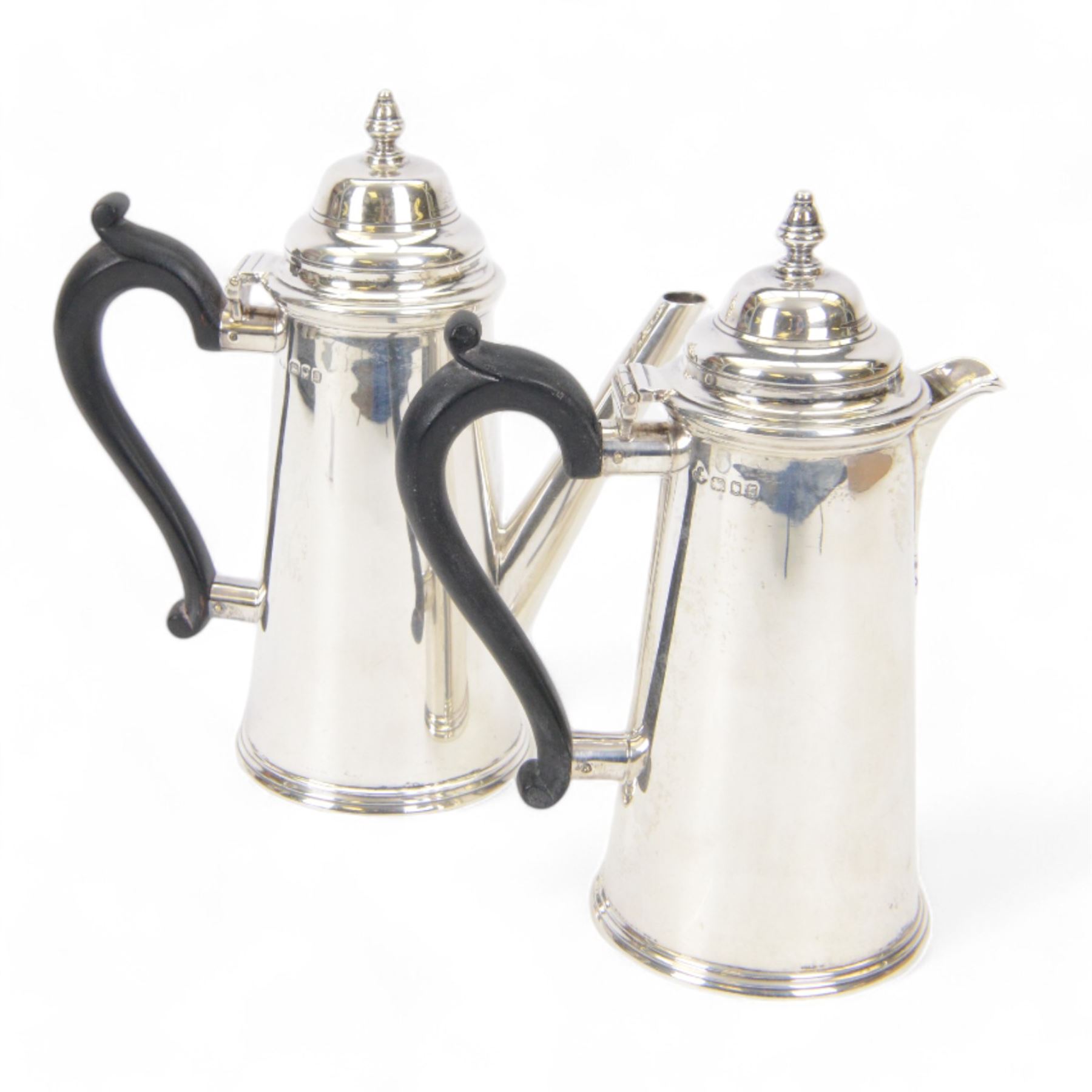 1930's silver two piece cafe au lait set, comprising coffee pot and a hot milk jug, each of tapered cylindrical form, with ebonised handles, hallmarked Nayler Brothers, London 1933, H19cm