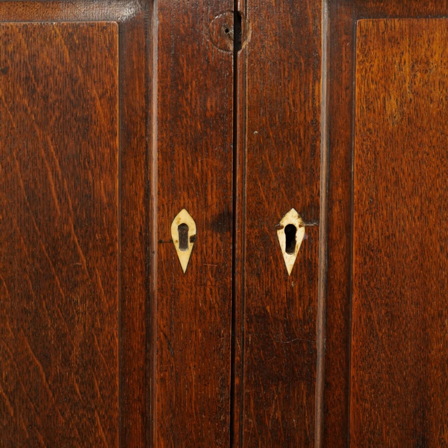 George III oak and mahogany bound enclosed bookcase-secretaire, panelled cupboards over four drawers