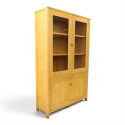 Ercol - contemporary oak 'Bosco' display cabinet, fitted with two shelves enclosed by glazed doors, over two cupboard doors, raised on stile feet