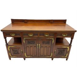 Late 19th century Aesthetic Movement walnut sideboard, fitted with four cupboards and three drawers, brass hinges and handles, carved detail