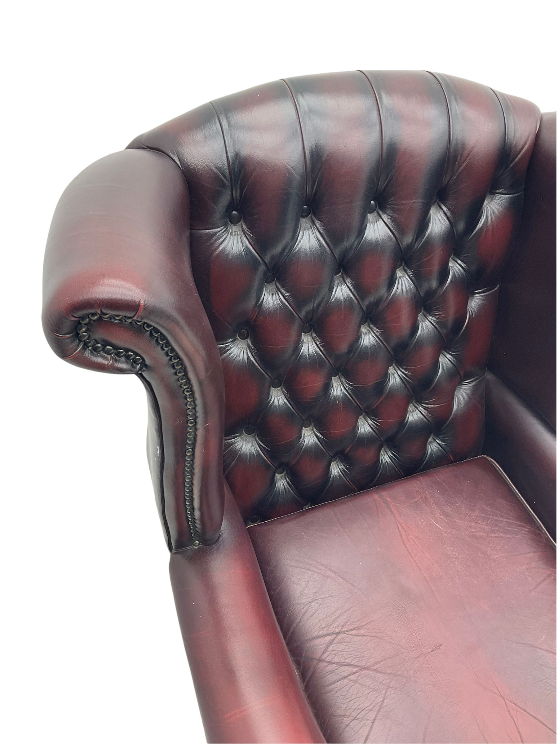 Thomas Lloyd - Georgian style wing back armchair, upholstered in buttoned oxblood leather