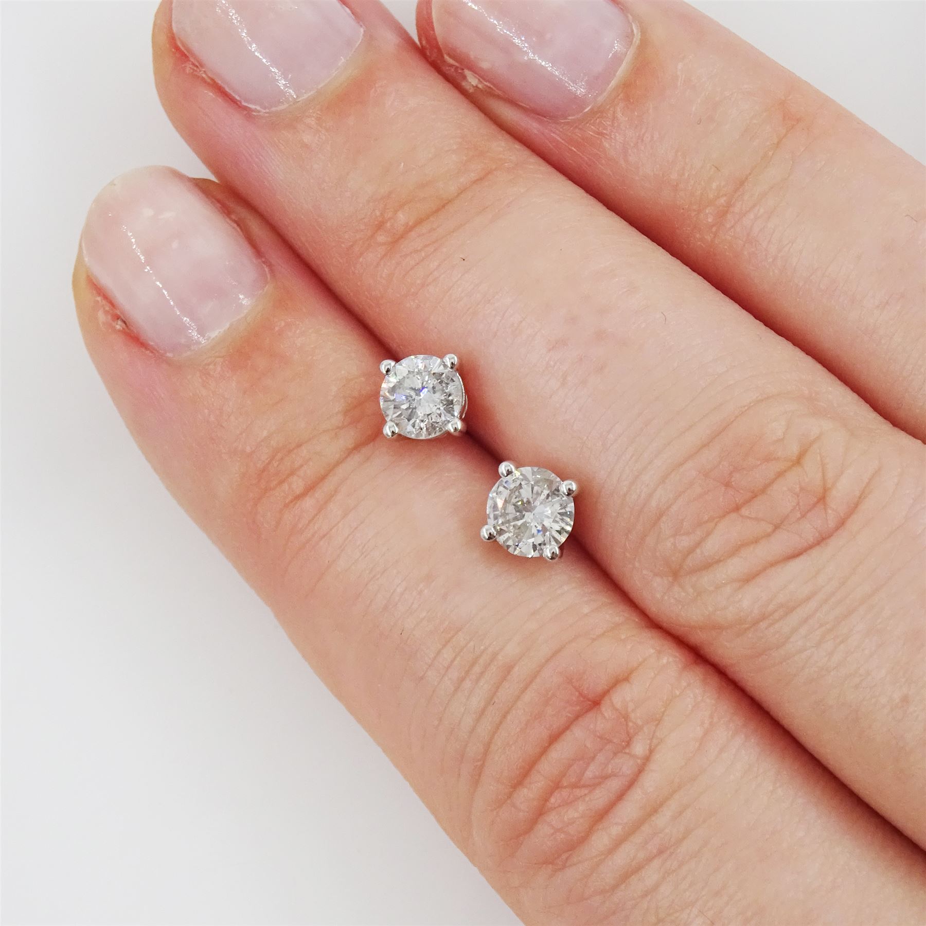 Pair of 18ct white gold round brilliant cut diamond stud earrings, stamped, total diamond weight approx 0.80 carat