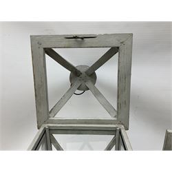 Two wooden lanterns with four glass sides, loop handles and open tops, largest example 58cm