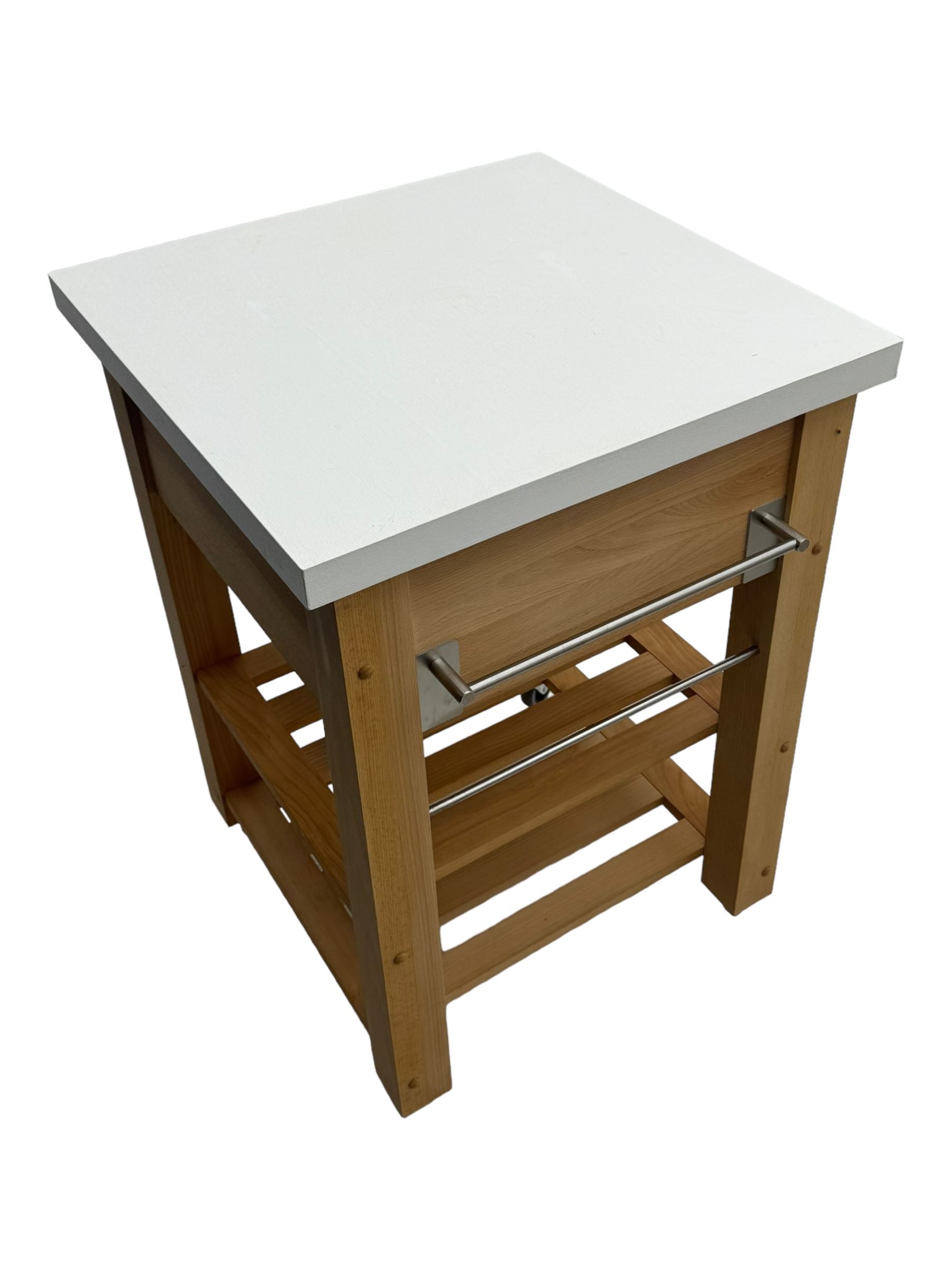Contemporary butchers block kitchen trolley, white square top over beech frame, single pull-out drawer, dual slatted shelves, chrome towel rails, raised on square supports with castors