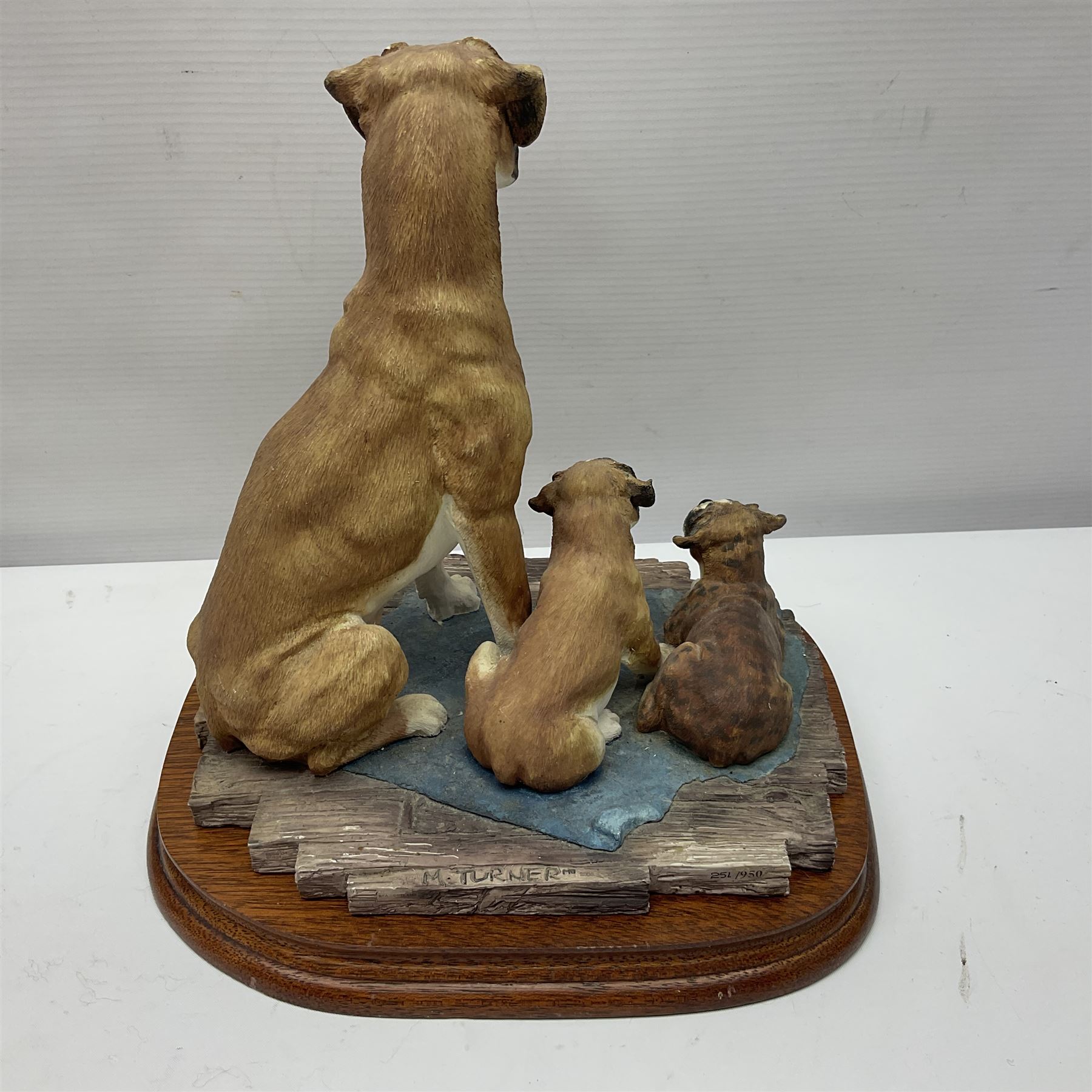 Three Border Fine Arts figures including Boxer with Pups, Capodimonte figure of a drunken pirate, and a brass dog (5)