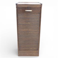 Early 20th century oak tambour front fitted cabinet, rectangular top with rounded corners over a roll tambour front enclosing a fitted interior of multiple shallow drawers with cut-out pulls, the sides with rounded uprights, on a stepped plinth base