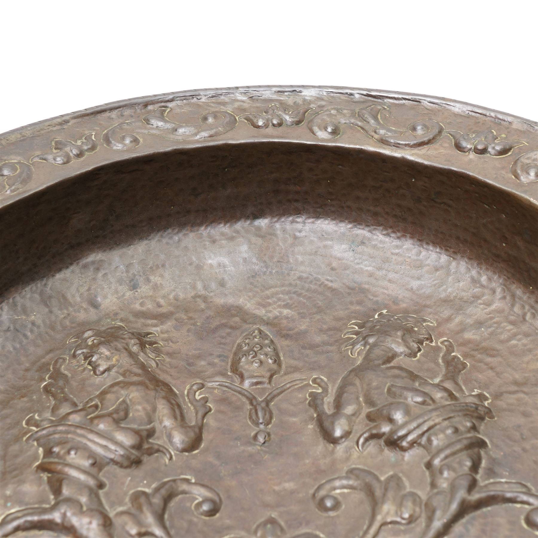 18th century Venetian copper two handled brazier, the base embossed with figures emerging from a cornucopia and a bishop's mitre, the border with embossed scrolls etc D50cm