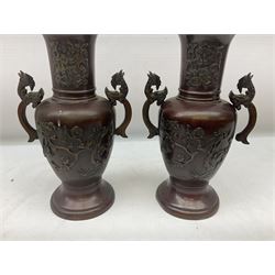 Pair of bronze Japanese vases of baluster form cast with birds amongst blossom and hoho bird handles, H28cm