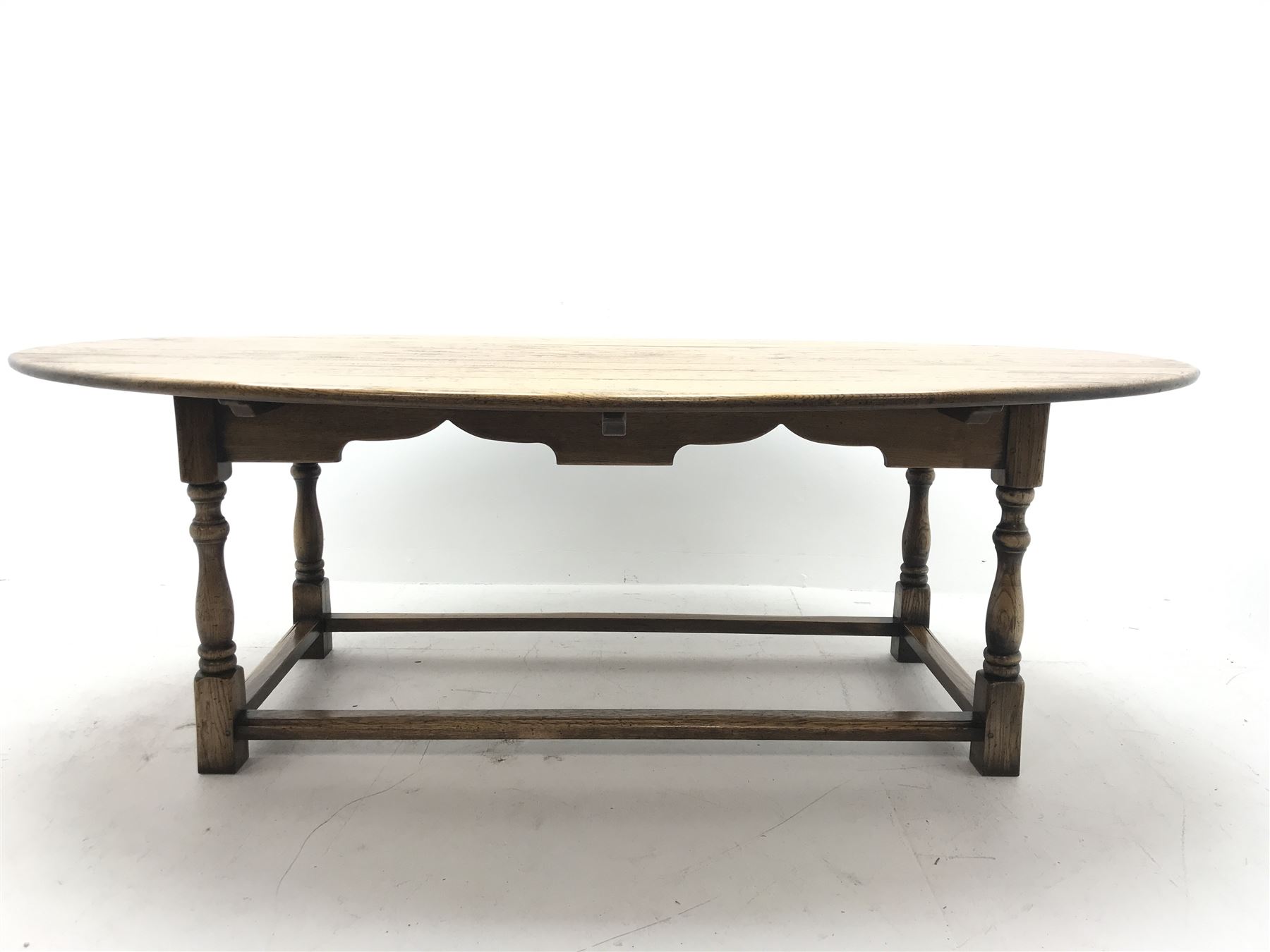 17th century style oval distressed light oak plank top dining table, rectangular stretcher base, L228cm, W150cm, H77cm