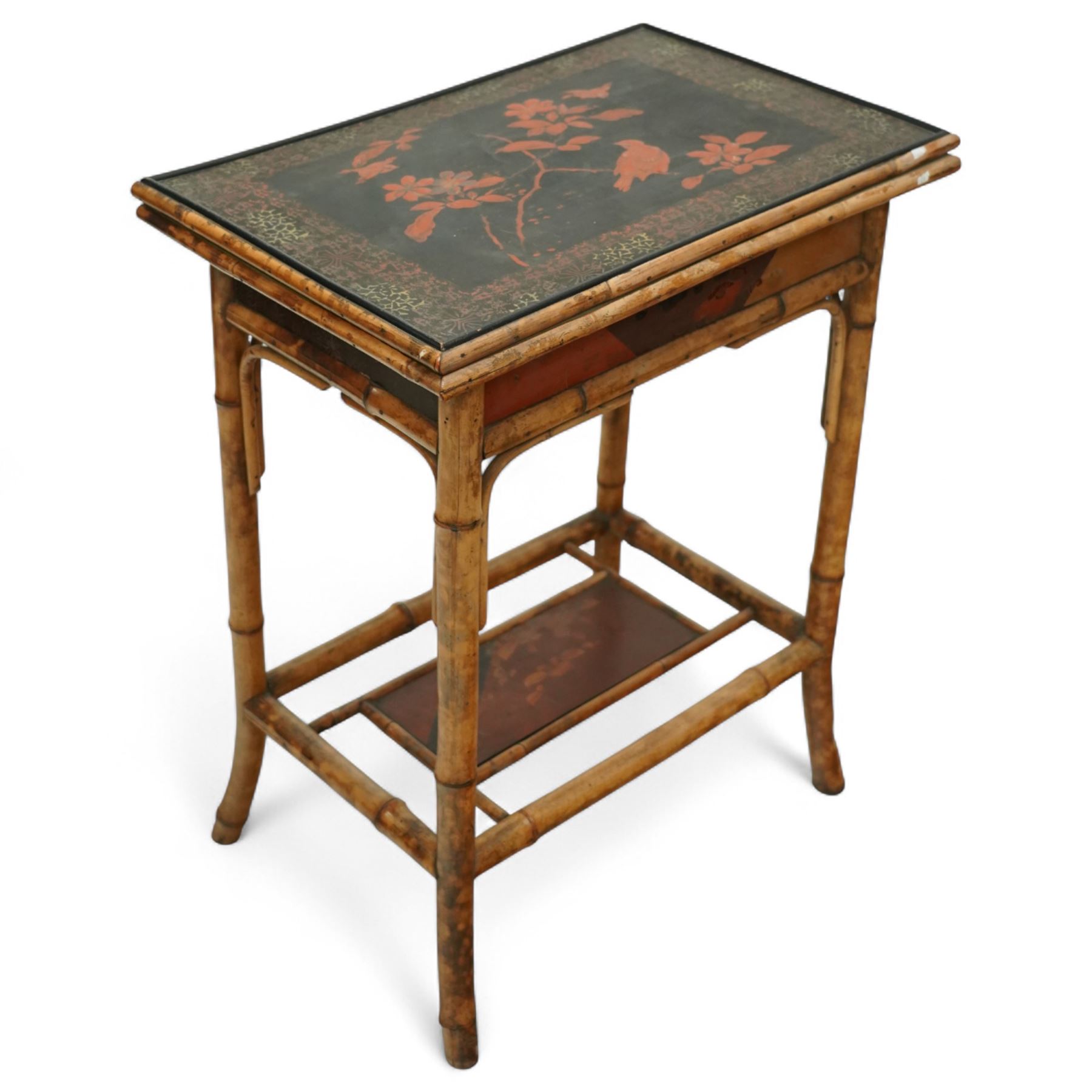 Late Victorian bamboo and lacquered card table, the top decorated with birds and floral sprays, hinged to reveal a baize playing surface, on bamboo effect legs with lacquered undertier