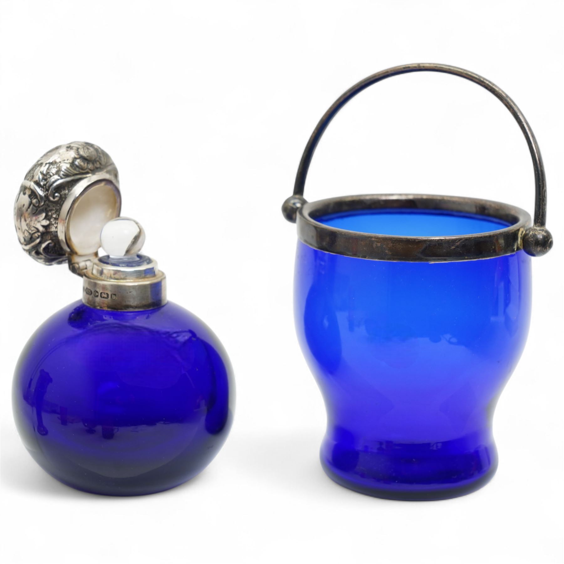 Late Victorian blue glass trumpet shape vase in pierced silver frame H20cm Birmingham 1899, modern blue glass globe scent flask with silver cover, two cranberry glass beakers in silver frames, cranberry sugar bowl in silver frame and blue glass sugar bowl with silver collar 