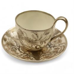 Three Pirkenhammer cups and saucers, two decorated with gilt birds in foliage on an ivory ground, the other with butterflies and foliate sprigs together with three  continental cups and saucers decorated with silver overlay 