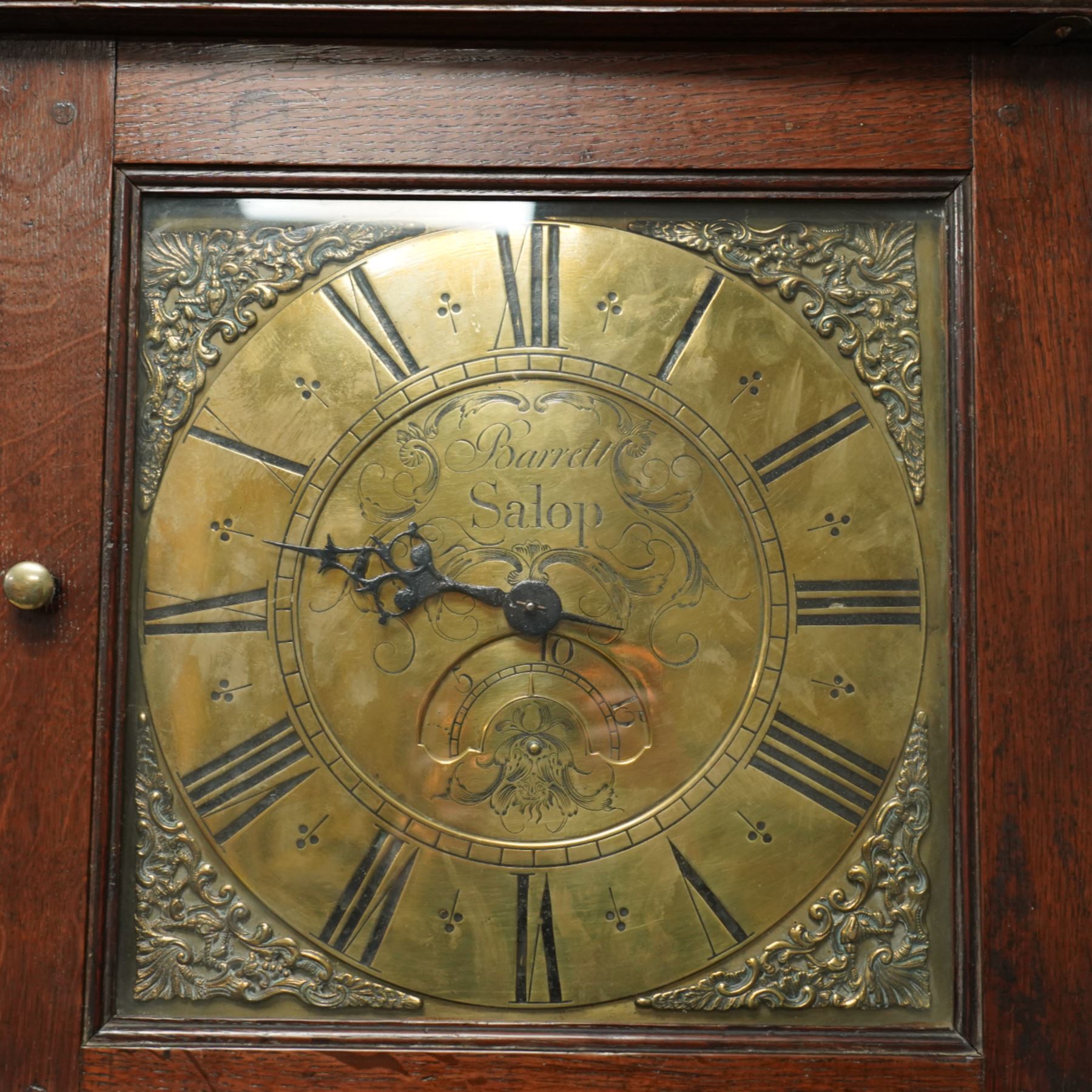 Barrett of Salop (Shrewsbury)-early 30hr provincial oak longcase clock c1730, with a flat topped hood and glazed square hood door beneath, long trunk door and a square plinth, brass dial with an engraved centre, makers name and date aperture, matching cast brass spandrels, single steel hand and engraved chapter with Roman numerals, half-hour markers and quarter-hour track, dial pinned directly to a chain driven count wheel striking movement, striking the hours on a bell. With weight and pendulum.  
