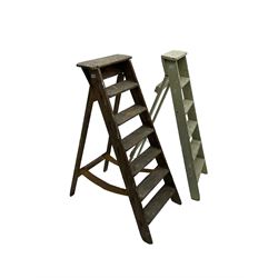 Early 20th century pine library or shop step ladder, seven tread (W45cm H135cm); together with another similar with painted laurel green finish (H135cm)