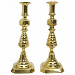 Early 20th century brass 'Mr Punch' doorstop H29cm, another 'Judy' H28cm, pair of brass Jack of Diamonds brass candlesticks H36cm, two other candlesticks and a chamber stick (7)