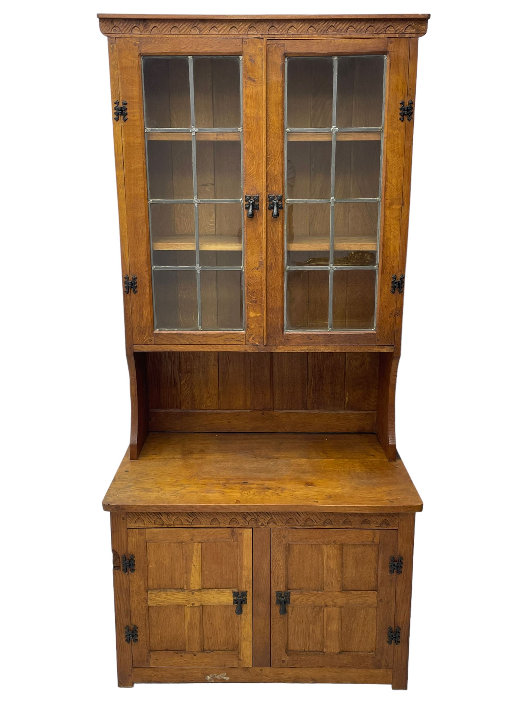 Gnomeman - adzed oak dresser, arcade carved cresting rail over two lead glazed doors, double cupboard below enclosed by two panelled doors, carved with gnome signature, by Thomas Whittaker, Little Beck 