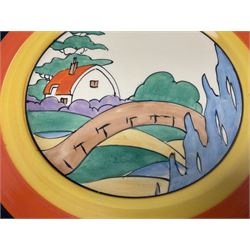 Clarice Cliff Bizarre for Newport Pottery Orange Roof Cottage pattern plate, circa 1932, hand painted with a stylised cottage and bridge landscape with yellow, orange and black banding, black printed mark beneath, D22cm 
