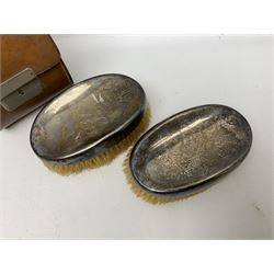 Two hallmarked silver hand brushes in fitted leather case, one example stamped Birmingham
