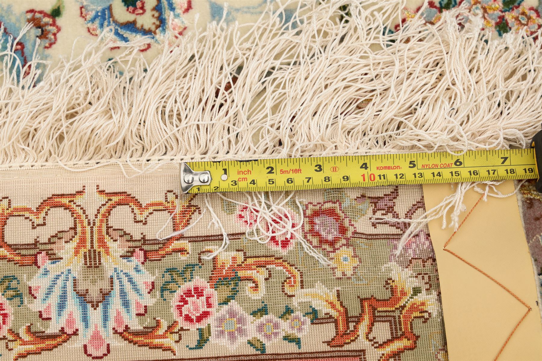 Fine Persian silk inlaid ivory and rose ground Tabriz rug, the busy field decorated with a central foliate pole medallion surrounded by scrolling foliage with trailing flowerheads and bouquets, the multiple guard lines filled with repeating scrolling palmettes and interlocking floral motifs