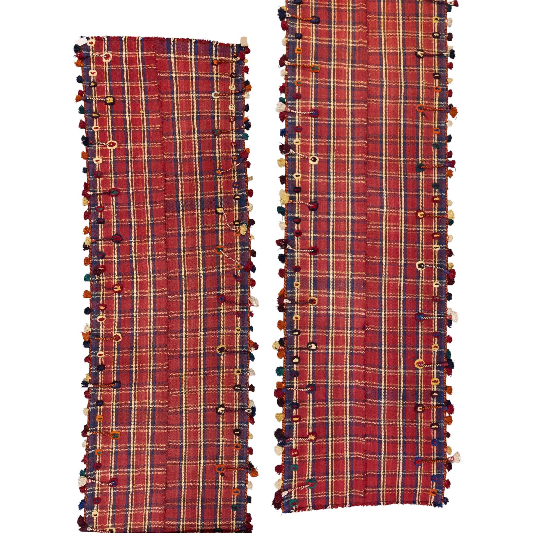 South West Persian Jajim kilim flatweave runner, composed of joined narrow woven bands,  field decorated with checked and striped motifs in shades of madder red, indigo, ivory ochre, and green, sides applied knotted wool tufts and braided elements with tasselled edges, (due to the large size, the runner is illustrated in two sections) 