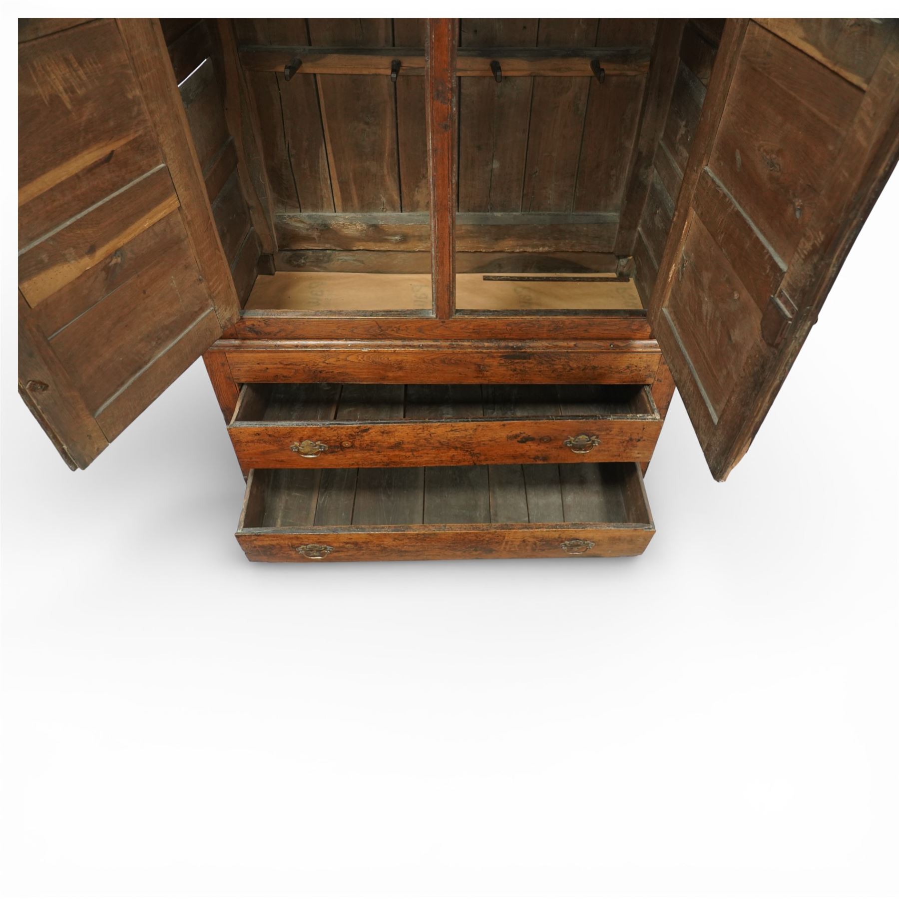 Georgian rustic oak housekeeper’s cupboard, moulded cornice above a pair of fielded panel cupboard doors enclosing a boarded interior with central divider and hanging hooks, the base fitted with two long drawers with brass swan neck handles, raised on stile supports