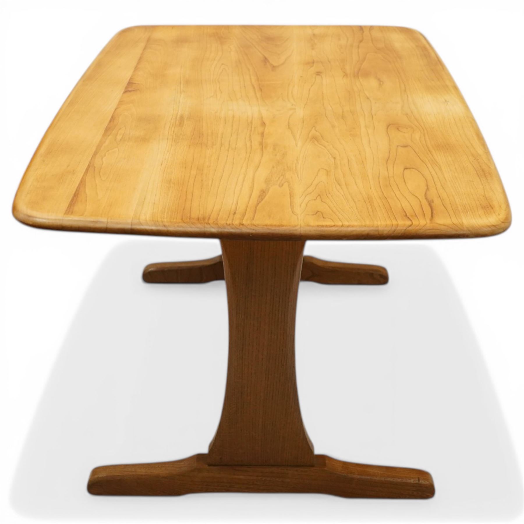 Ercol - mid-20th century golden elm and beech Windsor Range refectory style coffee table, rectangular top with rounded corners raised on end supports with sledge feet