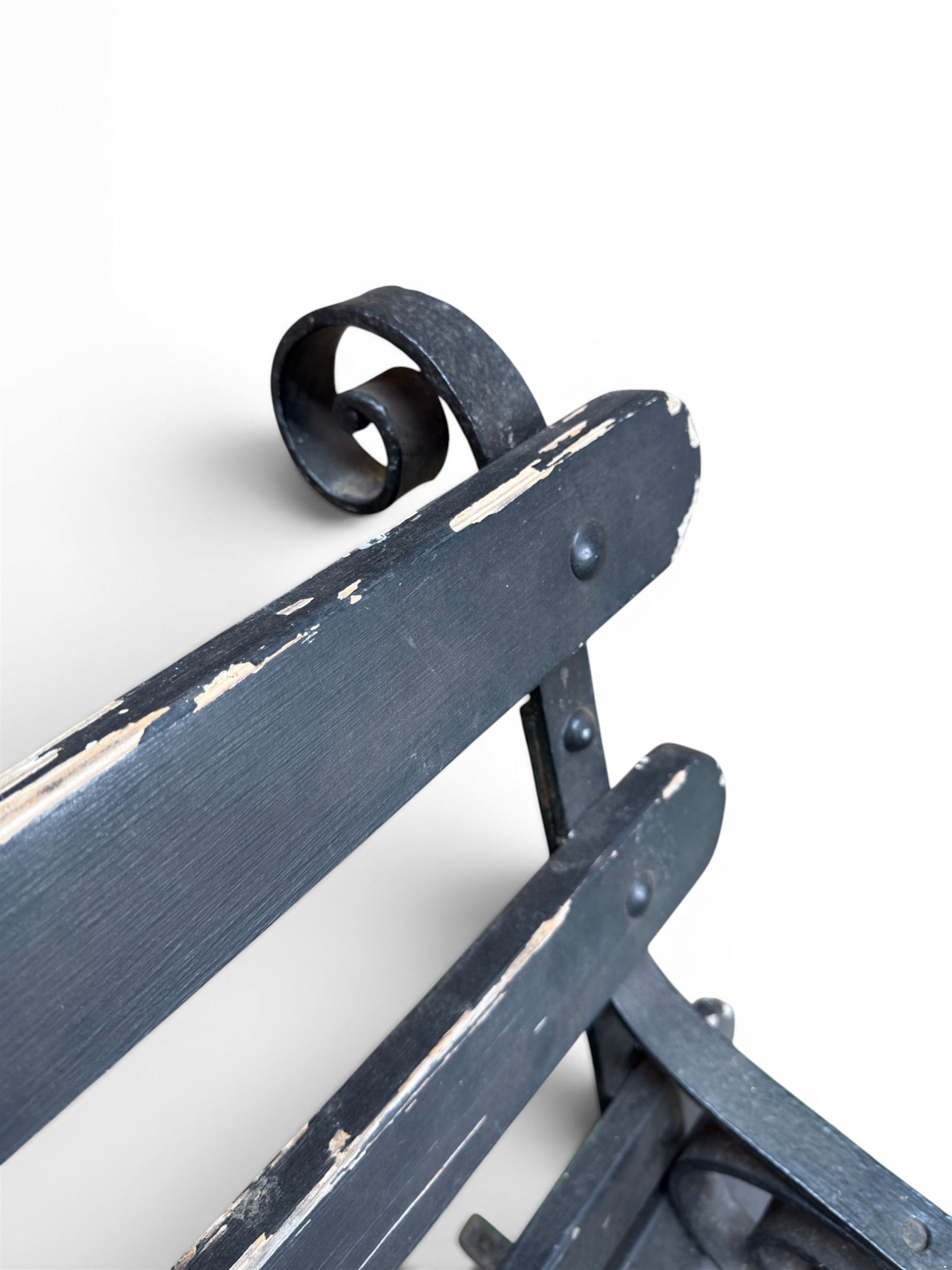 Coalbrookdale - rare pair of wrought iron and slatted wood garden benches, the twin wrought iron strapwork bench-ends formed of four scrolls over splayed feet, number 77 in the Coalbrookdale Castings Catalogue (see illustration)