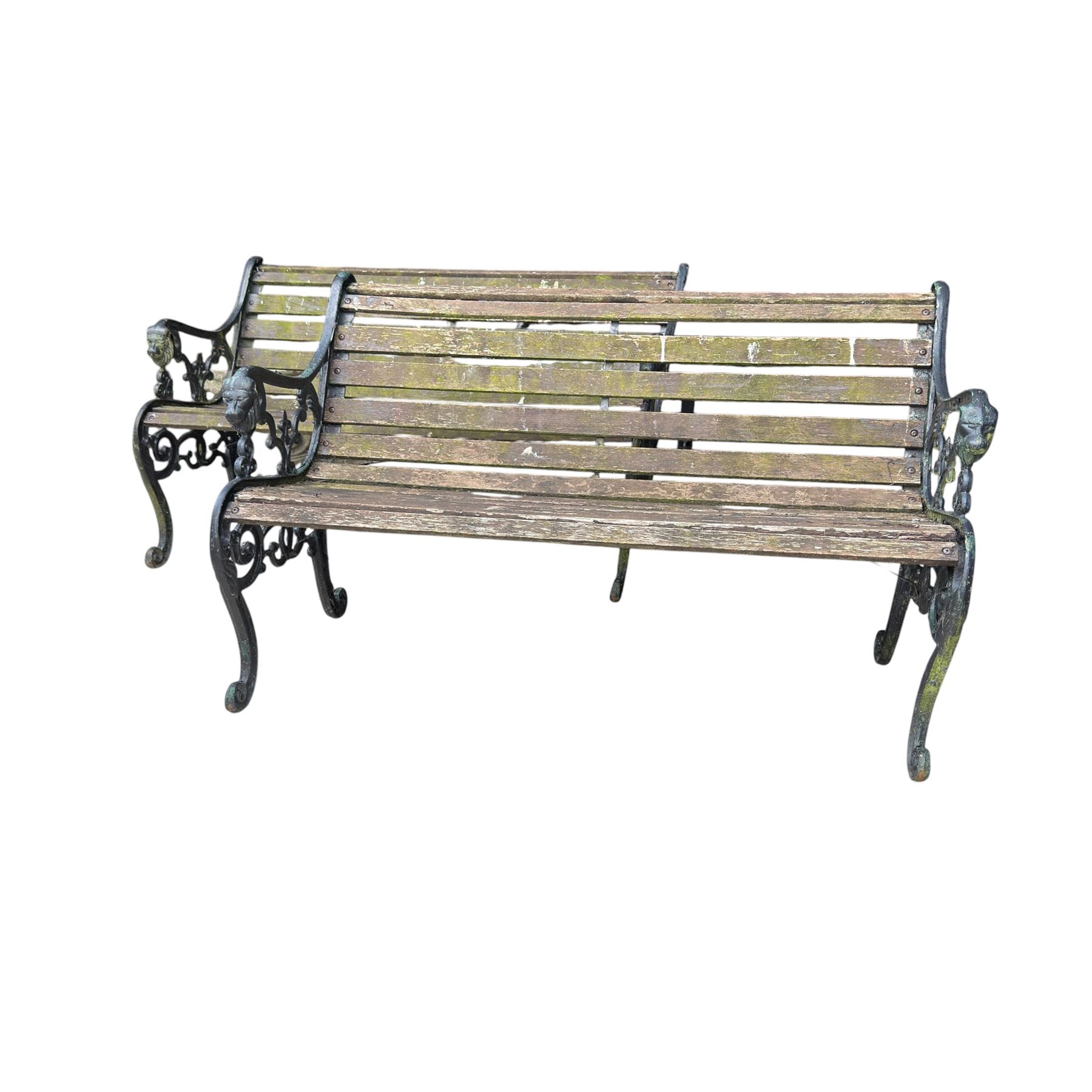 Pair of Victorian Revival Coalbrookdale design 'Dog and Serpent' pattern benches with slatted seats, the cast iron end supports of pierced and scrolling design with dog mask arm terminals