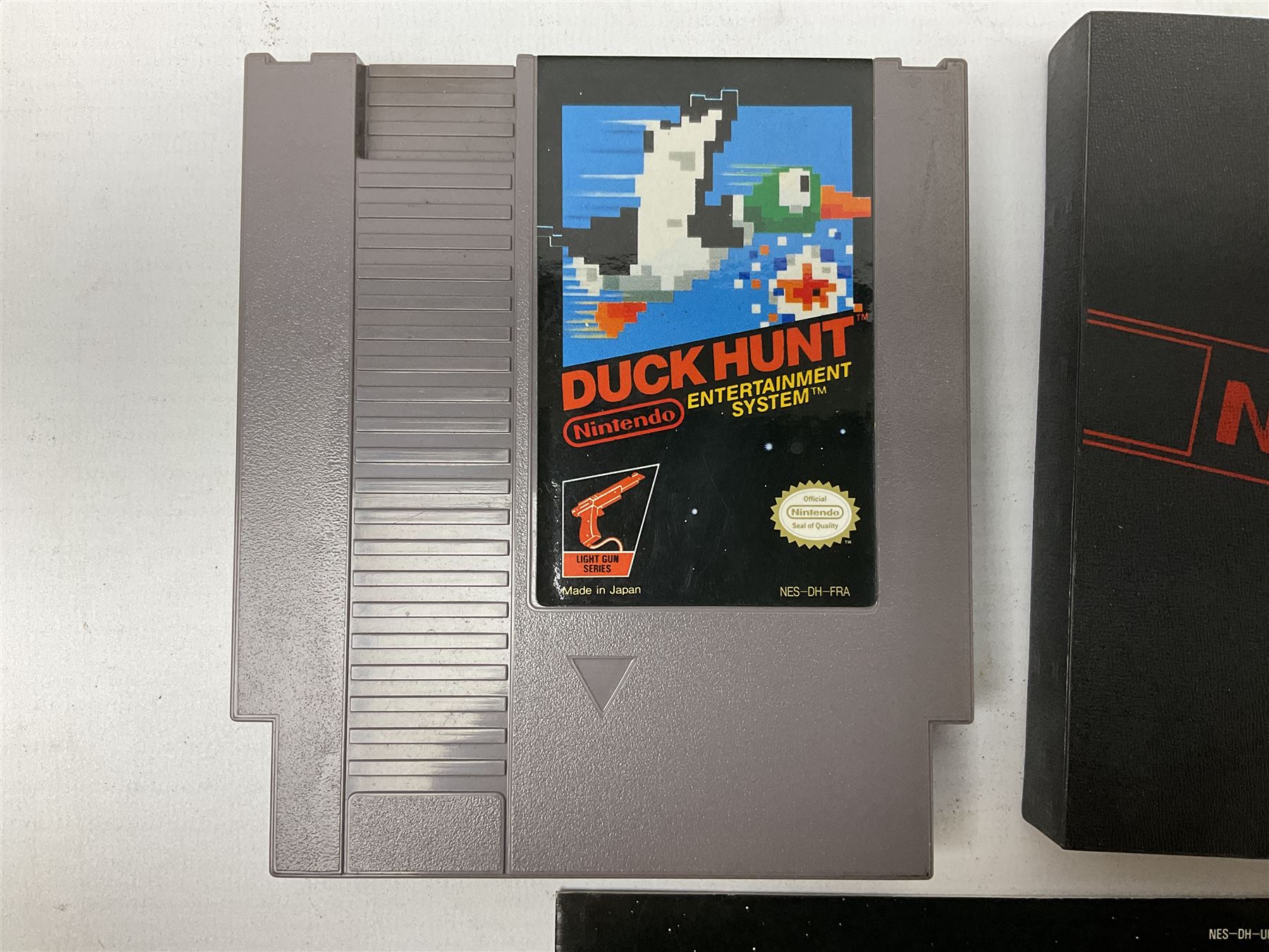 Nintendo Entertainment System (1985) console with two controllers, accessories and instruction booklet. NES Games ‘Duck Hunt’ with Nintendo Zapper gun, ‘Pinball’ and ‘Super Mario Bros.’, all with original sleeves and instruction booklets. NES game ‘Super Mario Bros. 2’ cartridge only