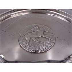 Modern limited edition silver salver, celebrating the achievements of Grundy, champion racehorse of 1975, each of circular form with gadrooned rim and plaque to centre depicting jockey mounted upon Grundy, designed by Stuart Devlin, limited edition no. 15/500, hallmarked London 1976, makers mark LH, D23cm, within silver lined fitted box and limited edition certificate 
