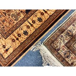 Persian ivory ground rug, central Mirab motif surrounded by floral decoration, guarded border with palmettes (131cm x 92cm); Persian design camel ground rug, central indigo Mirab motif, the guarded borders with scrolling flower heads (207cm x 128cm)