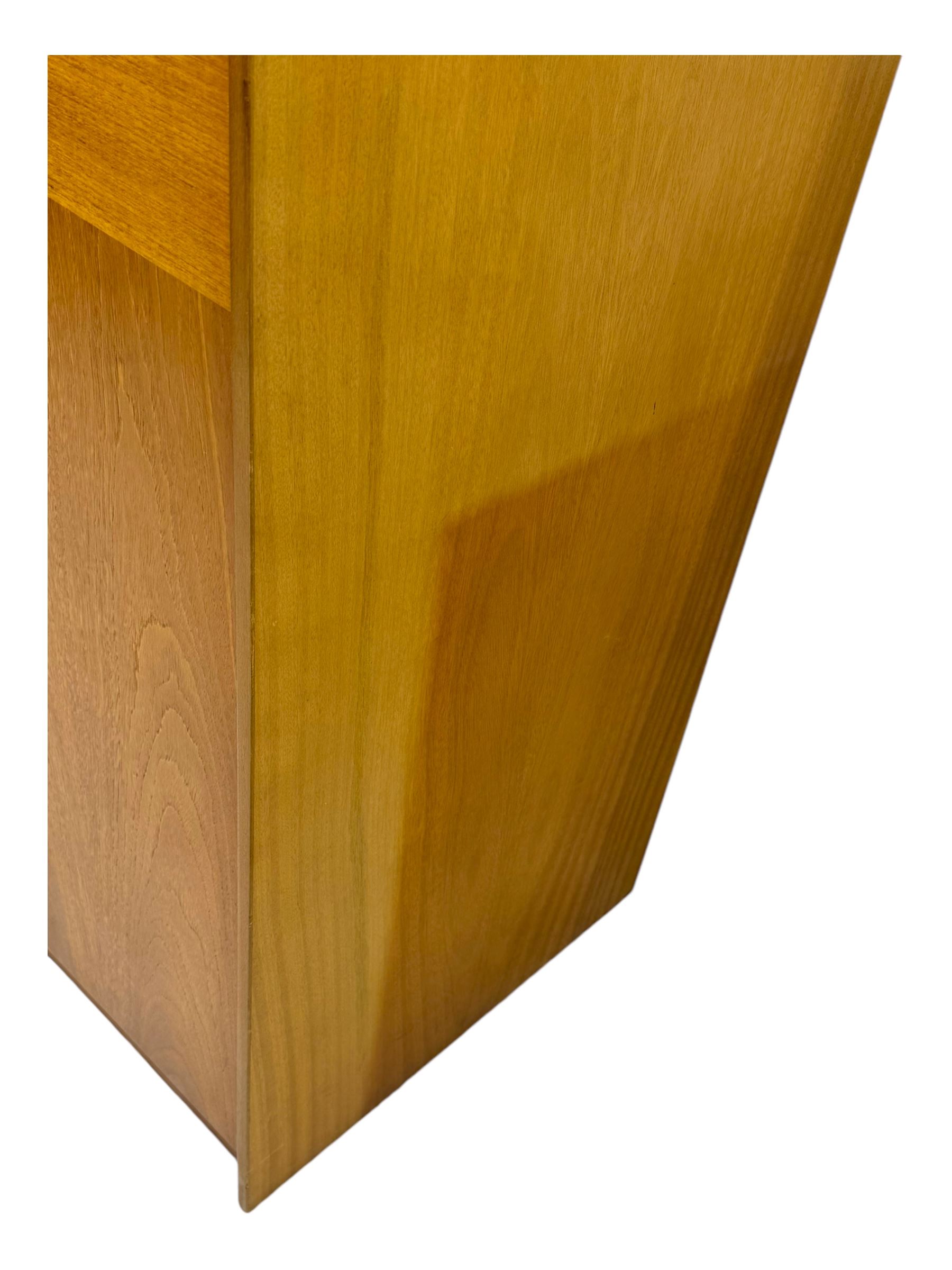 William Lawrence - mid-20th century teak double wardrobe, upper storage section over twin doors featuring recessed handles and contrasting horizontal panel, enclosing hanging rail compartment, towel rail, mirror, shelves and drawer, on plinth base with concealed castors