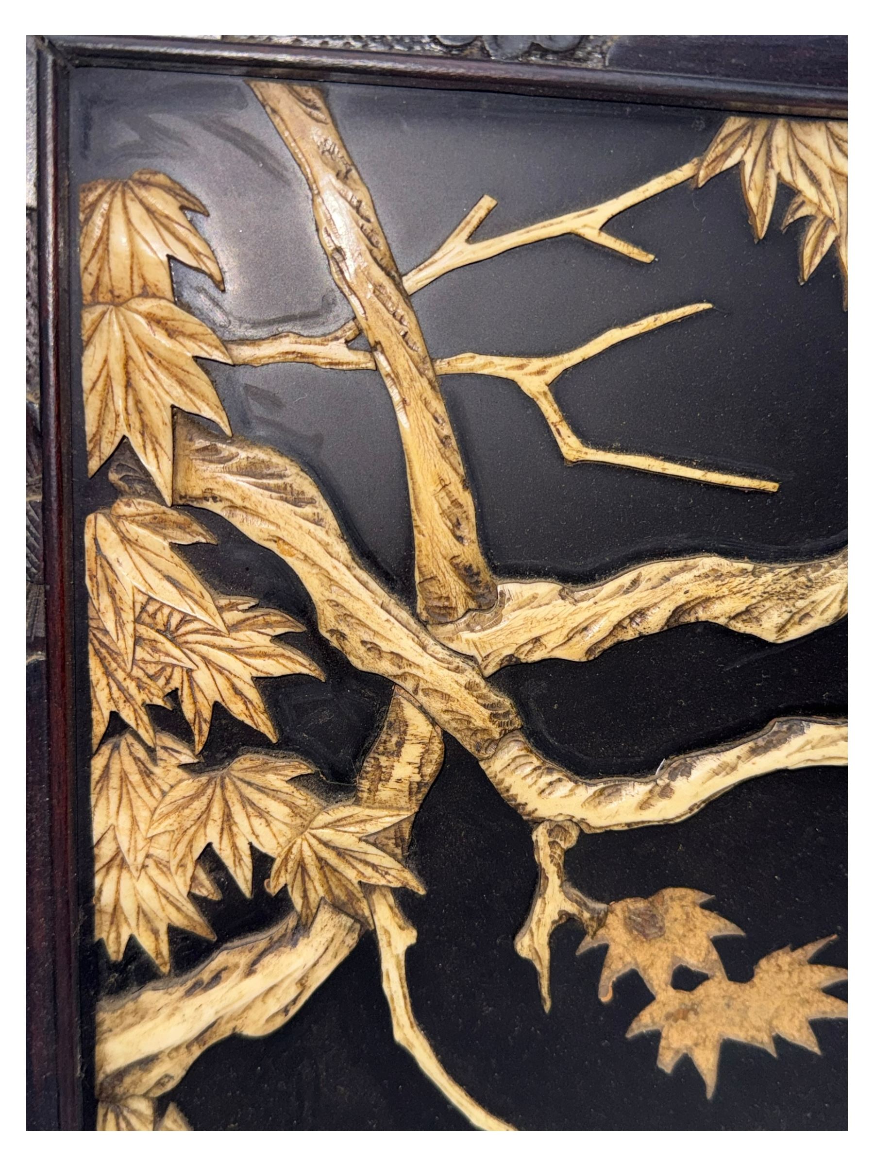 Meiji period (1868–1912), signed Shibayama carved hardwood lacquer panel inlaid with mother-of-pearl and ivory, decorated in high relief and inlaid, depicting two birds of prey with locked talons and beaks on leafy tree branch, signature in lower right corner, in original frame. This item has been registered for sale under section 10 of the APHA Ivory Act