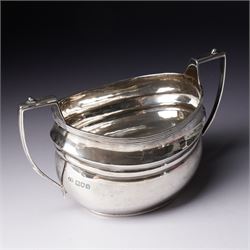 Silver three piece tea set of oval form, the teapot with ebonised handle and lift London 1913 Maker John Hunt and a pair of Victorian silver sugar tongs
