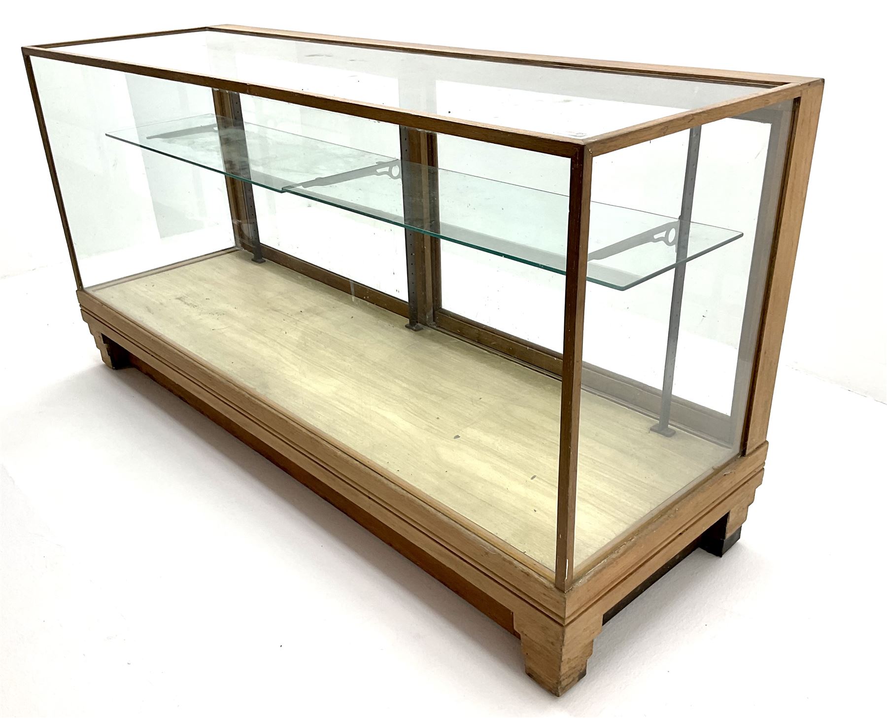 Mid century oak framed glazed display counter, two sliding doors, glazed shelves W182cm, H91cm, D61cm