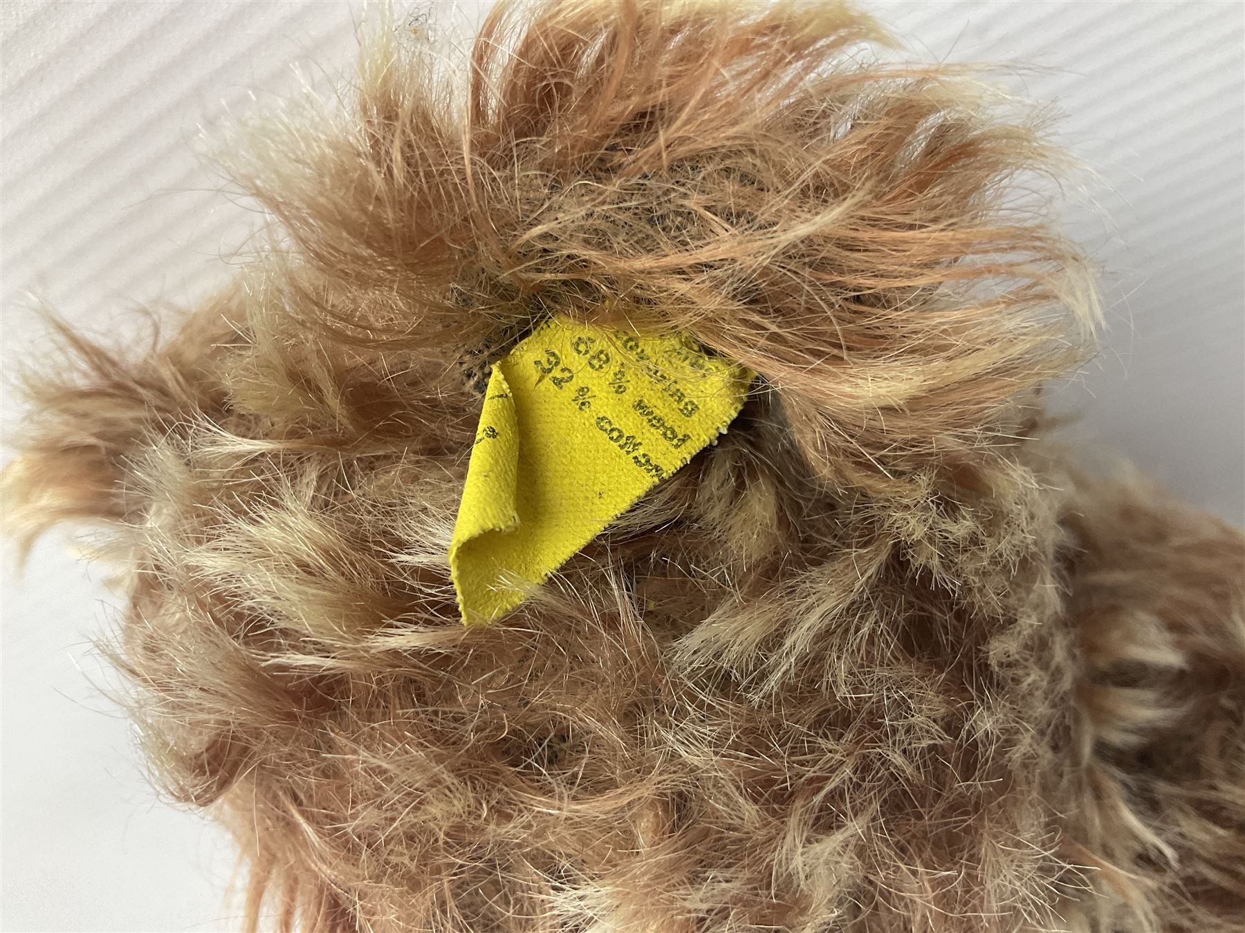 Steiff teddy bear with golden plush body, revolving head, applied eyes, vertically stitched nose and mouth and jointed limbs; button to left ear H26cm; and two other Steiff teddy bears, each with open mouth and button with tag to left ear (3)
