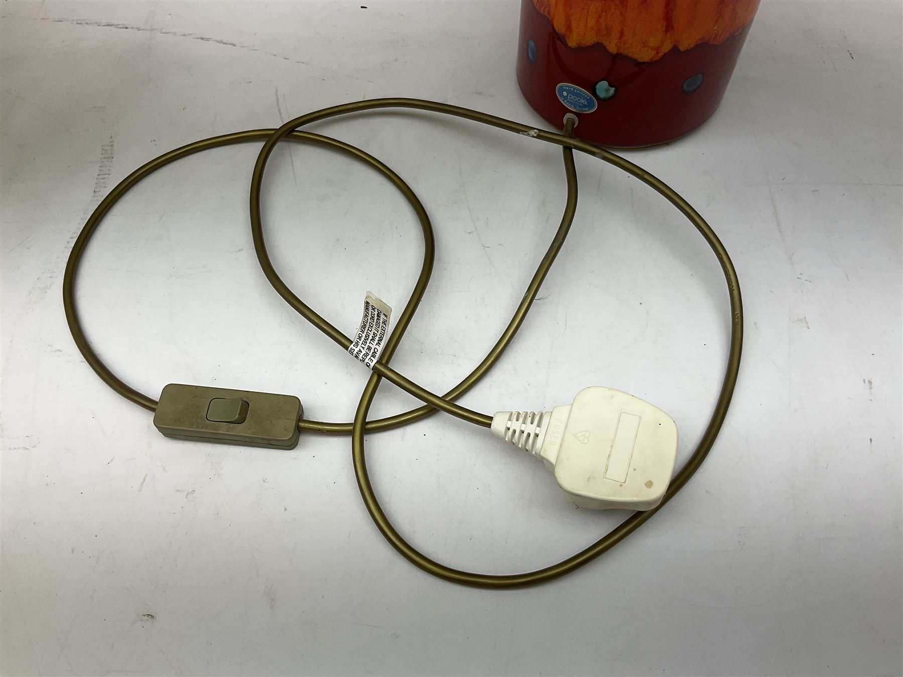 Poole Pottery table lamp in Volcano pattern of cylindrical form, with a cream lampshade, lamp H30cm