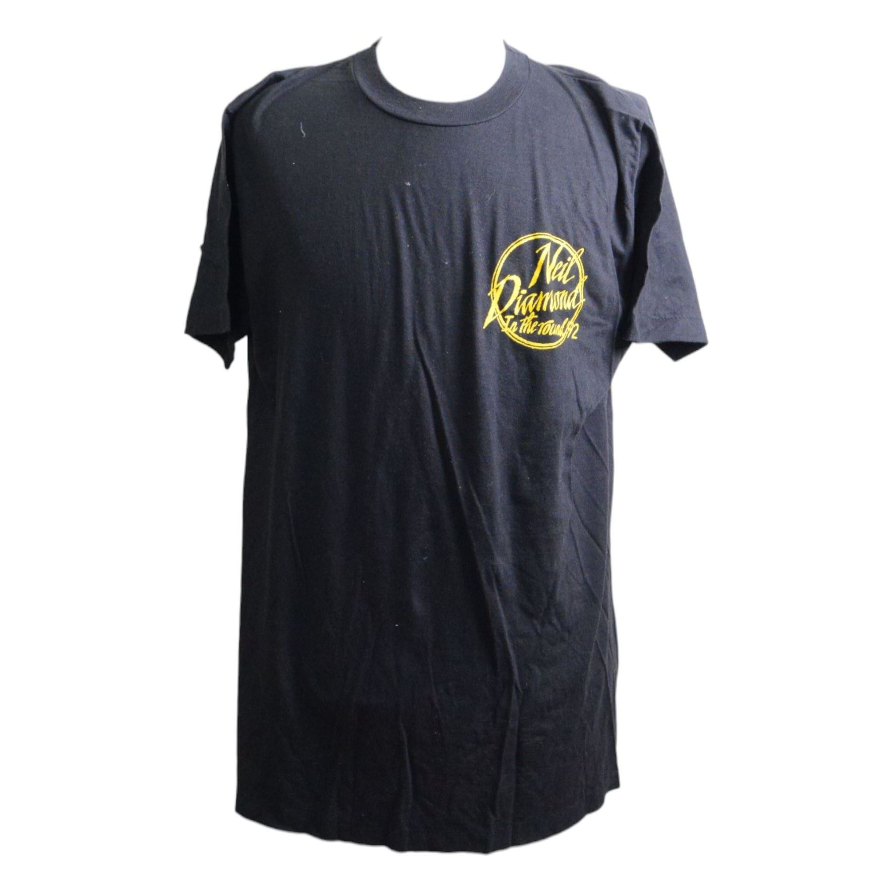 Neil Diamond tour memorabilia, including five t-shirts, cap, programmes, calendar and biography, together with a Neil Diamond In Concert poster, framed