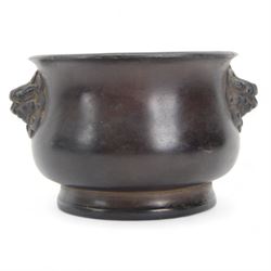 Chinese bronze censer, of circular bellied form with temple lion mask handles, upon a circular foot, with apocryphal six character Xuande mark within a border of two dragons chasing a pearl, H7.5cm D10/5cm
