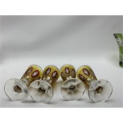 Set of four 19th century bohemian drinking glasses, the funnel bowls with ruby and yellow flashed and cut decoration upon faceted stems and feet, H11.5cm, together with a bohemian green flashed piggin, L20cm