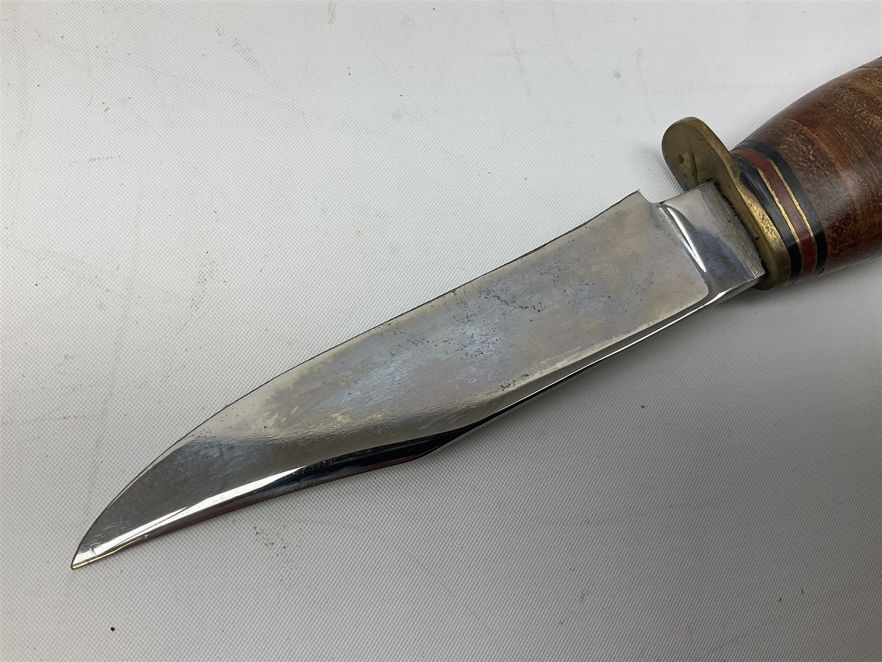 Graduated set of three Bowie knives by J. Nowill & Sons Sheffield England Est. AD1700, each with steel blade, brass cross-piece, stacked leather type grip and alloy pommel; largest blade 13cm and smallest 7.5cm; each in leather sheath (3)