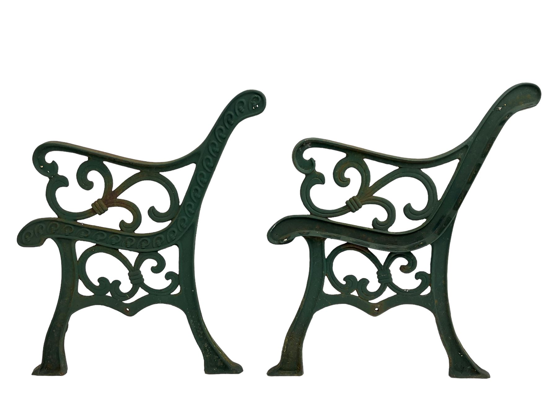 Pair cast iron garden bench ends decorated with scrolling design (H83cm), another pair of cast iron bench ends (H78cm), and a cast iron bench back decorated with foliage branches and roses (W110cm x H30cm)