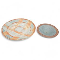 Tony Laverick (1961-); Charger painted with crossing horizontal and vertical lines of marbled blue and orange, the base signed with initials and dated '98, D42.5cm and a smaller bowl, signed with initials and dated '99, D26cm (2)